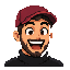 Samuel's pixel portrait: red cap, beard, black turtleneck, laughing